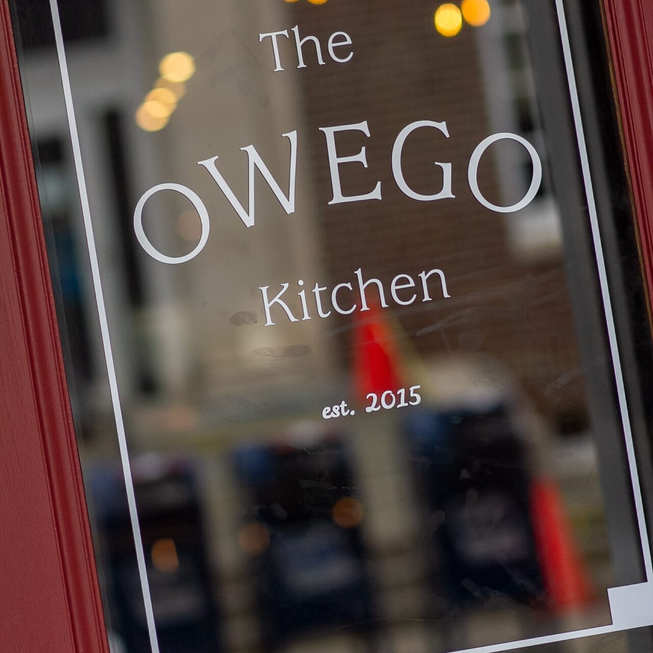 closeup of front door which reads "The Owego Kitchen est. 2015" in simply font